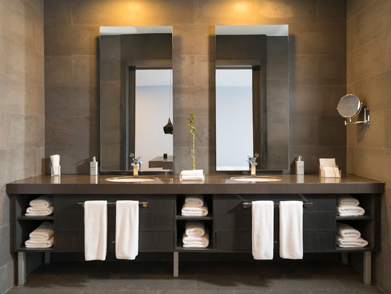 Luxury bathroom remodel with double vanity and stone tile